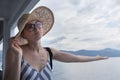 Disappointed female tourist on summer cruss ship vacation, checking if it rains, looking angry at overcast cloudy sky Royalty Free Stock Photo