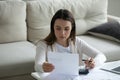 Focused woman read notification from bank feels disappointed