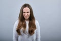 Disappointed lady crying, squeezing face wearing fashion blue sweater