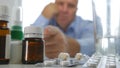 Disappointed Man Checking Medical Pills Stock On Pharmacy Shelf