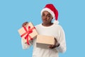 Disappointed Plump Black Woman Holding Bad Xmas Present, Blue Background