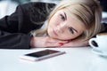 Disappointed sad woman looking at phone and waiting message or call Royalty Free Stock Photo