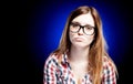 Disappointed and sad young girl with large nerd glasses Royalty Free Stock Photo