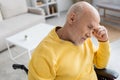 Disappointed senior man sitting in wheelchair