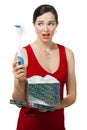 Disappointed woman holding dish brush gift.