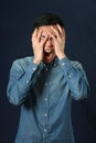 Disappointed young Asian man covering face by palms Royalty Free Stock Photo