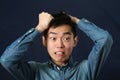 Disappointed young Asian man making face Royalty Free Stock Photo