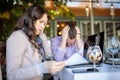 Disappointed young businesswoman reading negative sale reports