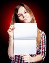 Disappointed young girl holding exercise book Royalty Free Stock Photo