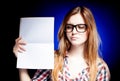 Disappointed young girl with nerd glasses holding Royalty Free Stock Photo