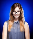 Disappointed young girl looking through the nerd glasses Royalty Free Stock Photo