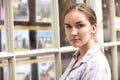 Disappointed Young Woman Looking In Window Of Estate Agents Royalty Free Stock Photo