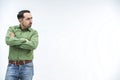 Resentful man, with arms folded, over white background looking to the side.