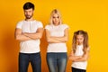 Angry Family Standing Crossing Hands Frowning On Yellow Studio Background Royalty Free Stock Photo