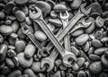 Disarrayed Wrenches and Spanners on Sea Stones A Grayscale Industrial Photo with Detailed Tools and Background Texture Royalty Free Stock Photo