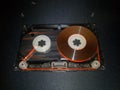 Disassembled audio cassette. Cassette film in open case. Vintage cassette repair.