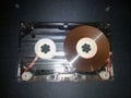 Disassembled audio cassette. Cassette film in open case. Vintage cassette repair.