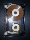 Disassembled audio cassette. Cassette film in open case. Vintage cassette repair.