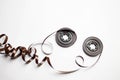 Disassembled audio cassette. Tangled cassette tape in knots. Old musical equipment. Royalty Free Stock Photo