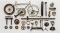Disassembled bicycle parts neatly arranged on a white background, showcasing a variety of components