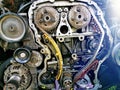 Disassembled car engine during repair. A close-up of an exploded view of the engine chain, gears and tensioners during repair and