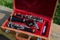 A vintage clarinet and case on a bench. Royalty Free Stock Photo
