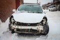 Disassembled damaged car after an accident on the street. Deformed hood. Royalty Free Stock Photo