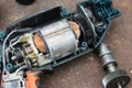 Disassembled electric drill on rusted background. Royalty Free Stock Photo