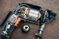 Disassembled electric drill on metal rusted background Royalty Free Stock Photo