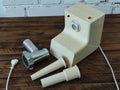 Disassembled electric meat grinder on the wooden table