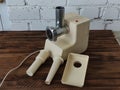 Disassembled electric meat grinder on the wooden table
