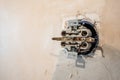 Disassembled electrical outlet in detonation wall with bare wires and hallmarks during repair in apartment Royalty Free Stock Photo