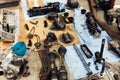 Disassembled engine components spread across workshop floor showing crankshaft, driveshaft, chains, housing and tools Royalty Free Stock Photo