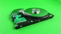 Disassembled hard drive close up on green background Royalty Free Stock Photo