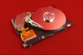 Disassembled hard drive close up on red background Royalty Free Stock Photo