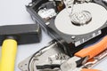 The disassembled hard drive next to the tools with which it was disassembled Royalty Free Stock Photo