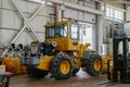 A disassembled Komatsu loader stands in the repair shop.