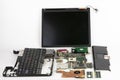 Disassembled laptop, basic components of notebook, screen, keyboard, processor, motherboard, internal hard disk drive, CPU fan