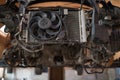 Disassembled machine front, car radiator and fan. Car engine removing. Detail of a car engine room