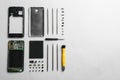 Disassembled mobile phone and repair tools on white background Royalty Free Stock Photo