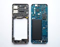 Disassembled mobile phone showing internal components. Circuit board with chips, wires, and battery exposed. Shows complex tech Royalty Free Stock Photo