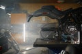 Disassembled motorcycle on table in biker garage workshop