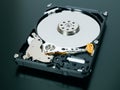 Disassembled open hard disk drive HDD of computer or laptop lies on dark matte surface. IT closeup. ÃÂ¡omputer hardware and