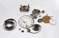 Disassembled parts of an antique clock, clock hands, gear wheels, torsion springs, clock faces, scrapped antique clock parts, Royalty Free Stock Photo