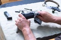 Disassembled pistol, safety cord and knife. Thorough cleaning of the gun. Pistol and cleaning cloth in hand