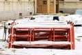 Disassembled scaffolding in the form of tubes, painted in red paint lie on the construction site for the restoration