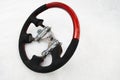 The disassembled steering part before installation of the equipment is a carbon alutex fibre orange wheel with soft genuine