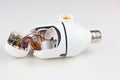 Disassembled white CCTV camera with a screw-type bulb, revealing the complex internal components, wiring, and circuit board on a Royalty Free Stock Photo