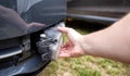 Disassembling and removing the fog lamp from a car to replace a burnt out light bulb. Close-up Royalty Free Stock Photo
