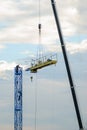 disassembly of construction cranes using a lifting arm with the assistance of workers Royalty Free Stock Photo